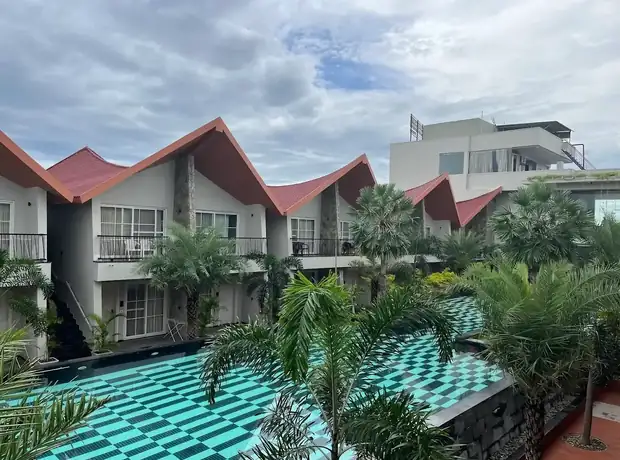 Poolside villas surrounded by tropical plants